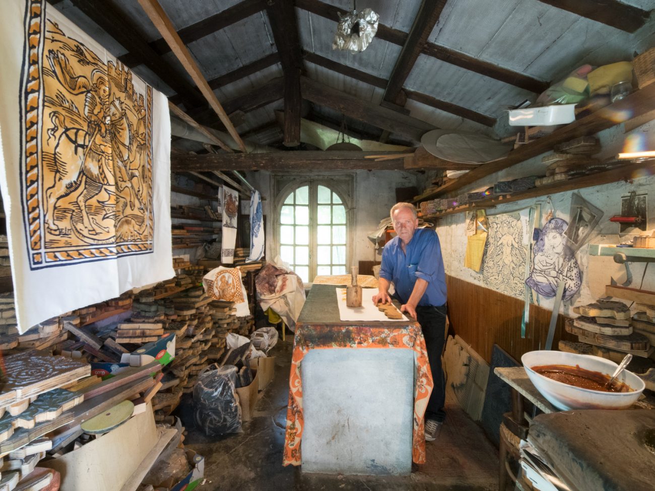 L'artista Egidio Miserocchi ritratto nel suo laboratorio con le sue tele